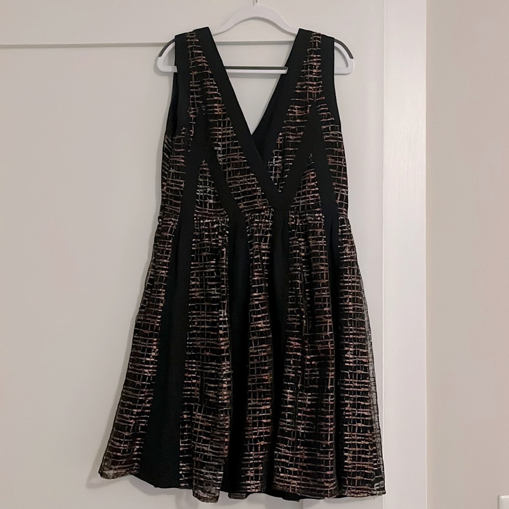Mid thigh sleeveless dress with plunging V neckline and back. Chiffon.
